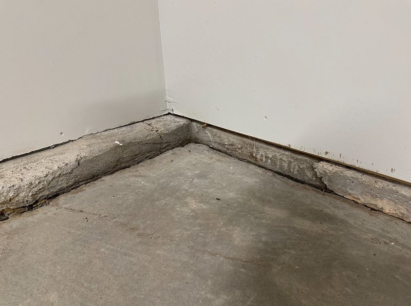 Visibly sloping hardwood floor inside a home caused by foundation settling